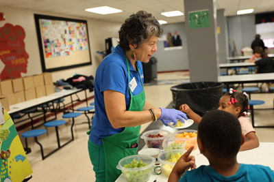 Virginia Cooperative Extension volunteer with students in cafeteria