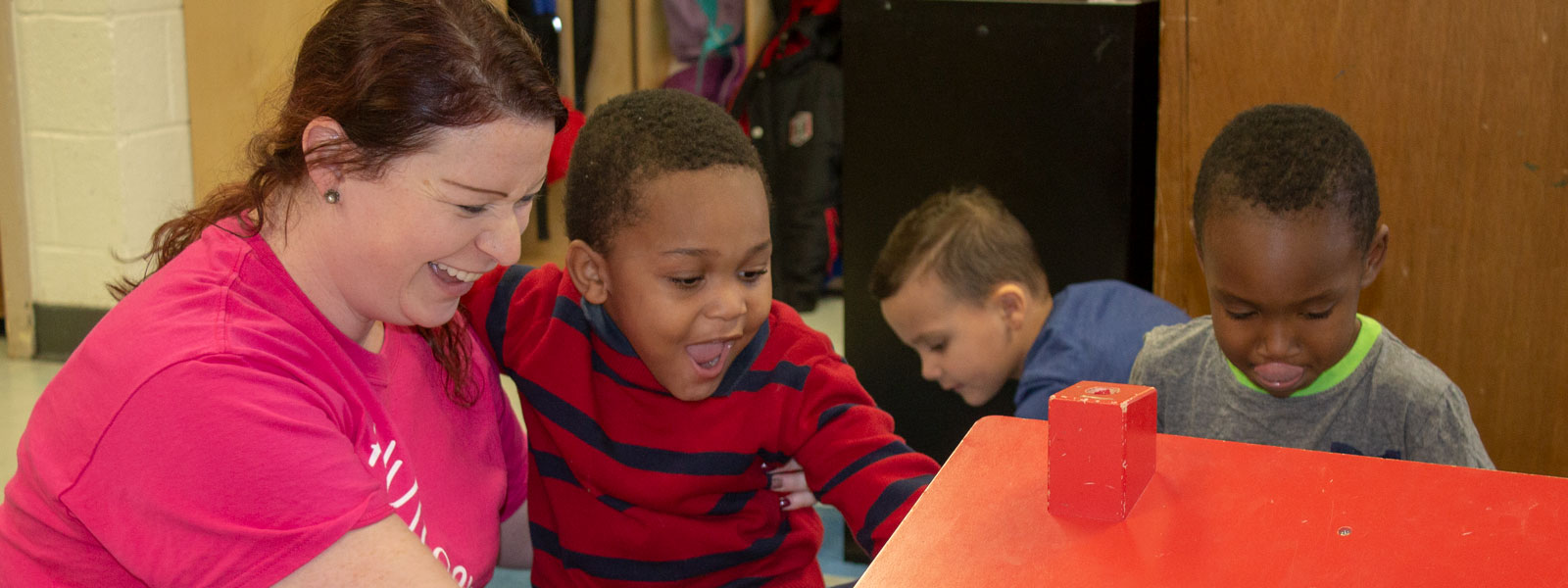 Pre-K teacher playing with students