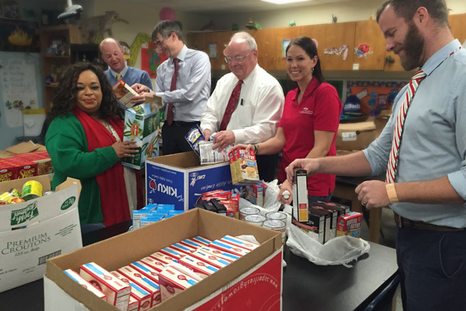 American National Bank employees and DESI staff sort food