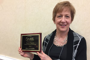 Woman holding plaque