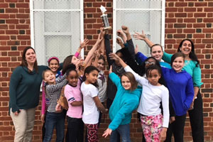 TCM flag and dance corps holding trophy