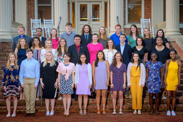 High school students standing on building steps