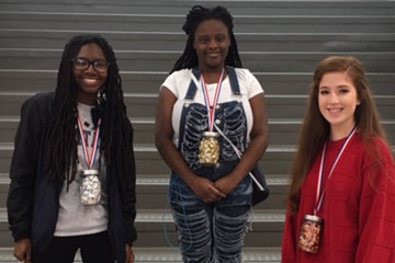 Science Fair winners standing on steps