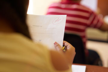 Student holding graded paper