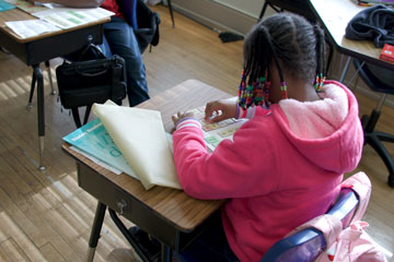 Girl at desk working with letters