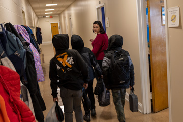 Teacher with students in hallway