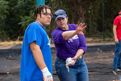 E. C. Glass football player with Kaboom staff during playground build project