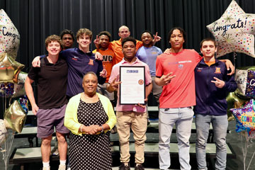 Group of students on stage with award