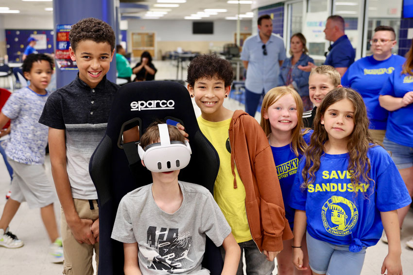 Students at event with VR headset and chair