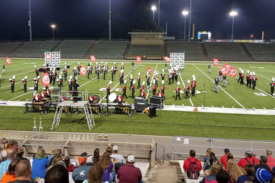 Marching band performing at night at City Stadium