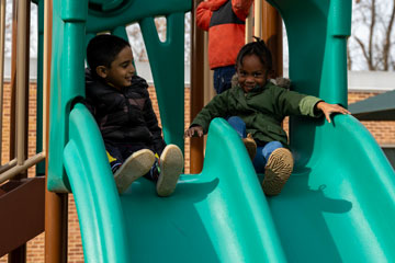 Pre-K students on playground slide