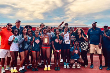 Girls track team holding state championship trophy