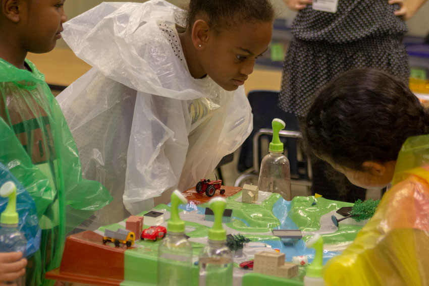 Girl looking at watershed model