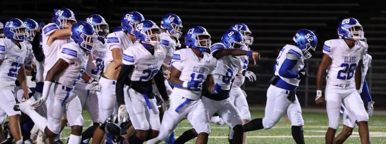 Football players running onto field