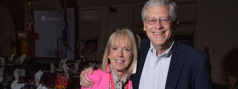 Man and woman smiling at event